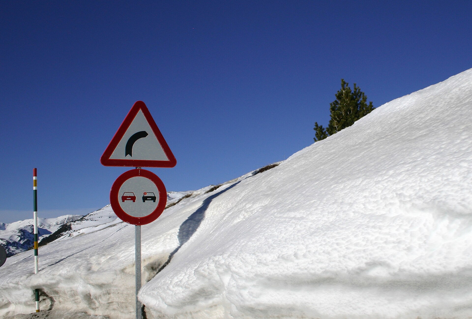 Road sign surrounded by deep snow at Port d'Envalira near Pas de la Casa