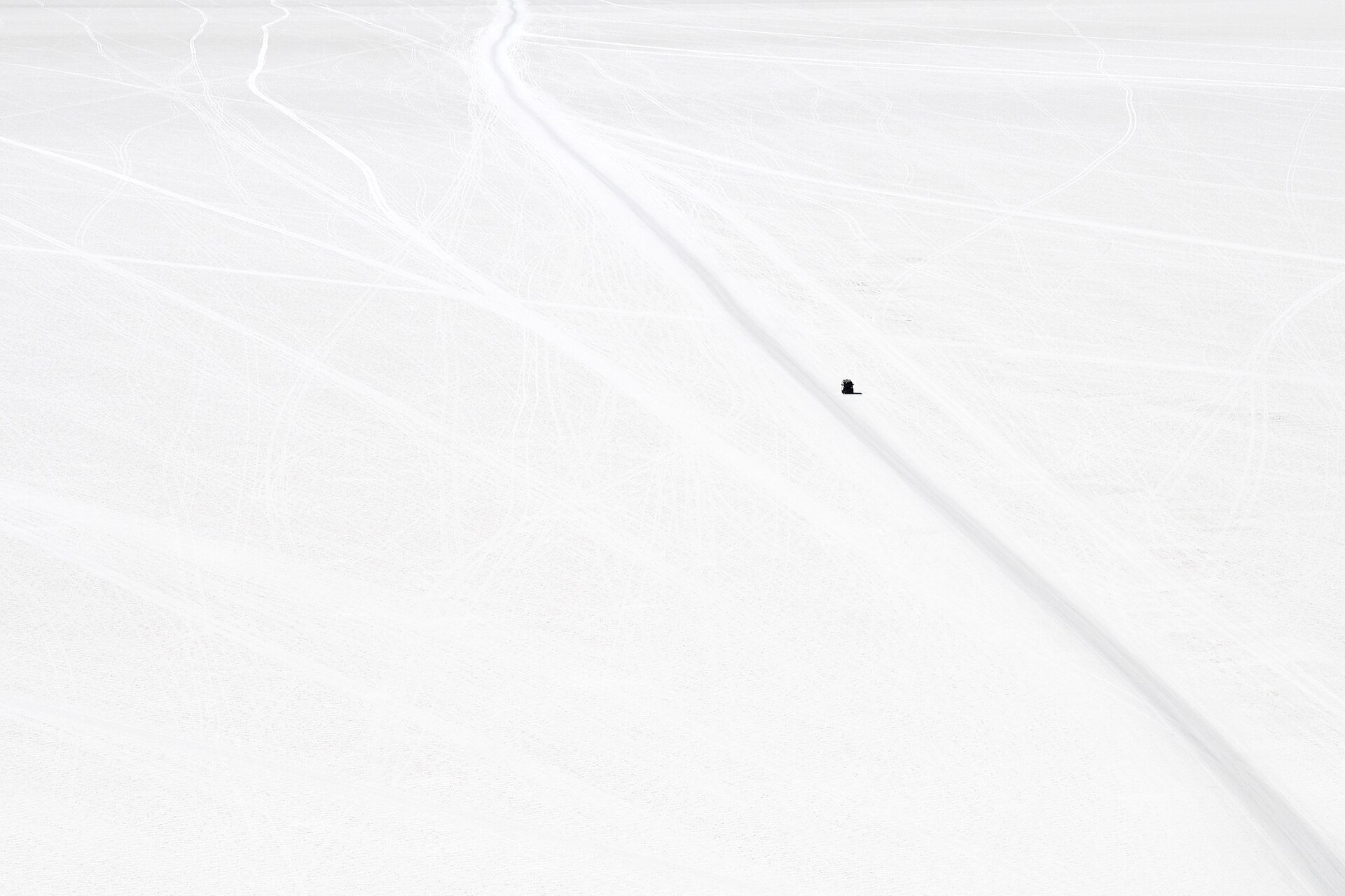 Four-wheel-drive tracks crossing the Salar de Uyuni salt flat