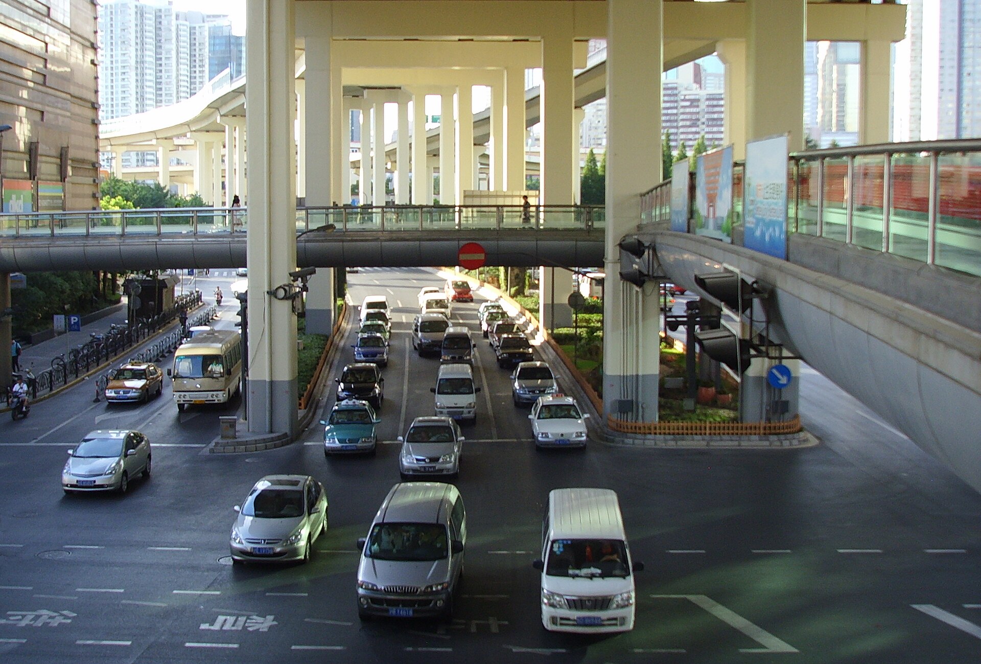 Urban traffic beneath an elevated road at a Shanghai intersection