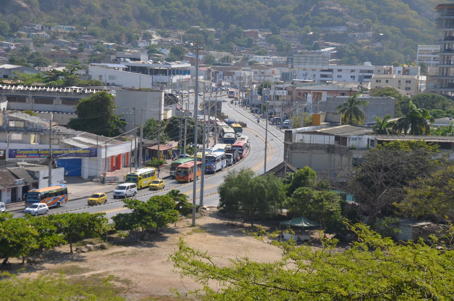 Buses and cars moving through a busy Cartagena road toward the historic centre