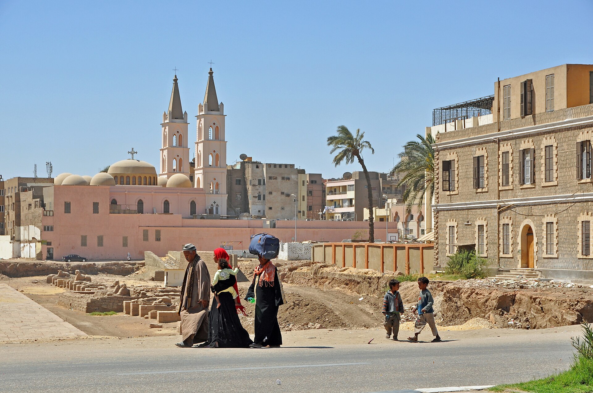 Street scene in Luxor, Egypt, with pedestrians and a paved road