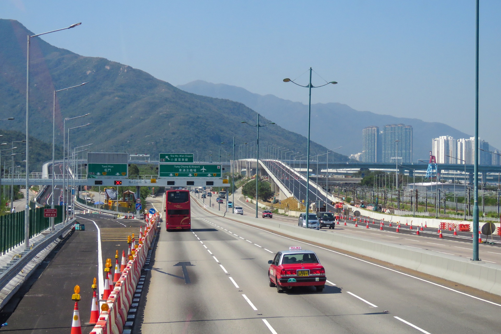 North Lantau Highway interchange with direction signs and mountains