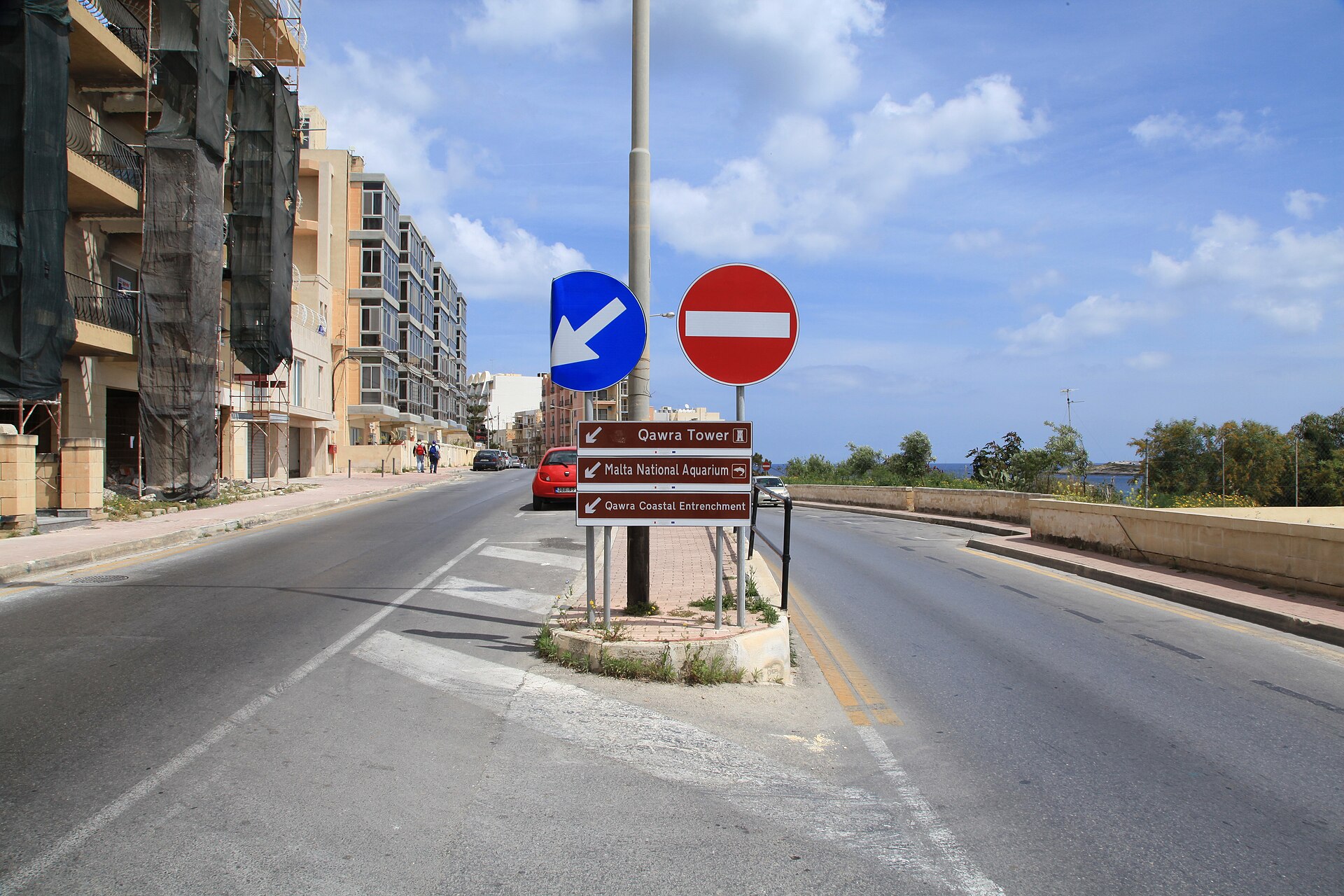 Road signs beside a coastal road in St Paul's Bay, Malta