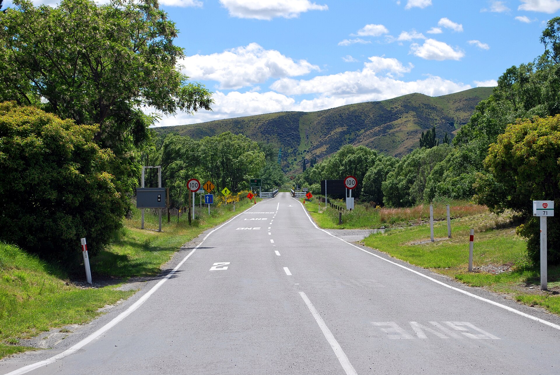 New Zealand State Highway 82 near Kurow with road markings and a one-lane bridge route