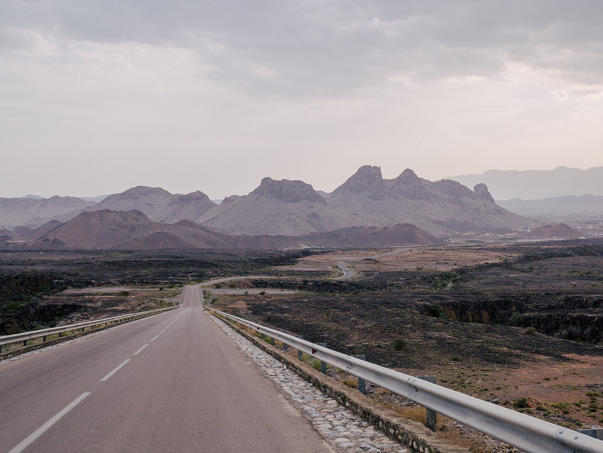Paved mountain road leading toward Jebel Akhdar in Oman's Hajar Mountains