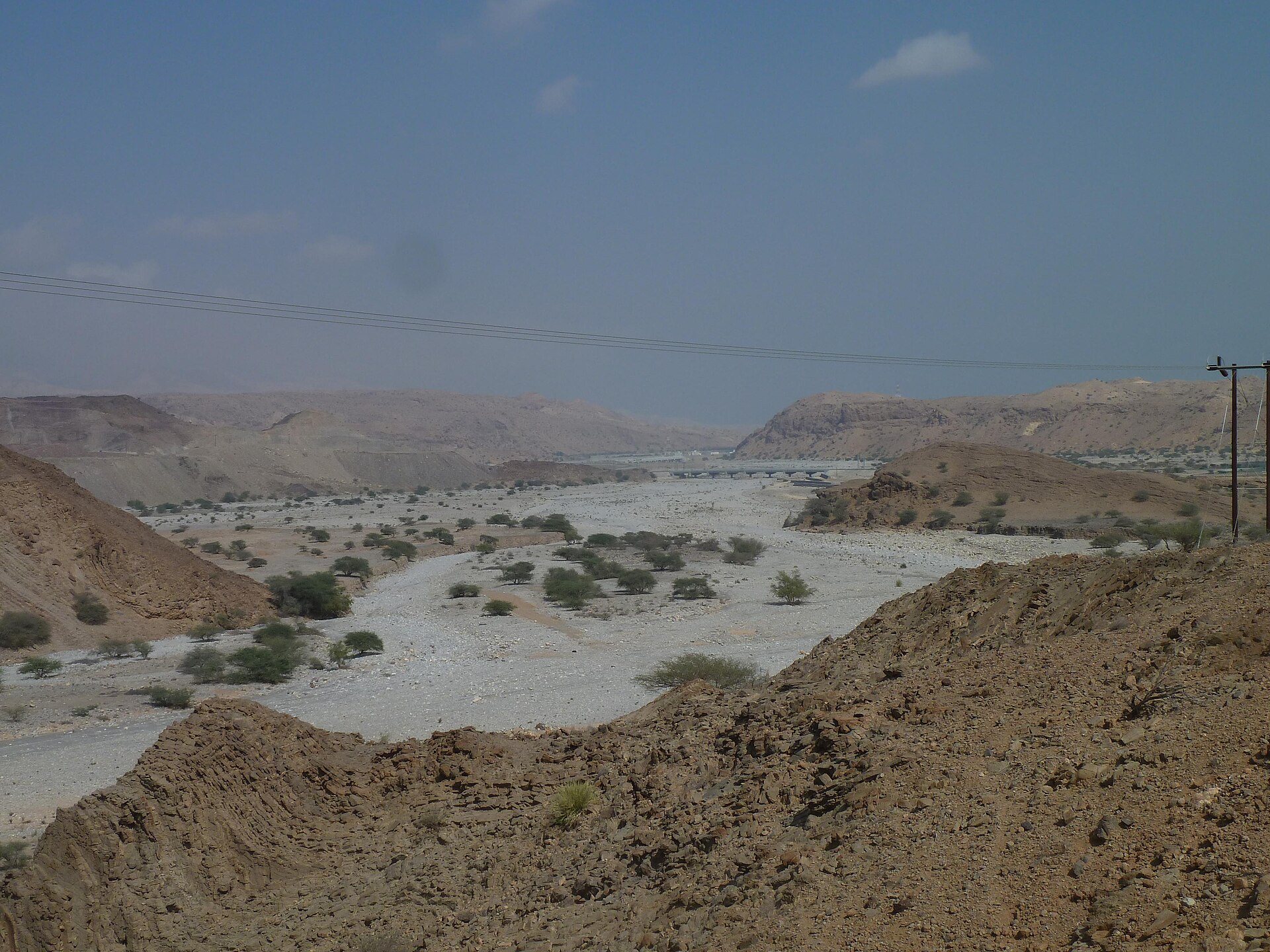 Dry wadi channel and rocky hills in Oman
