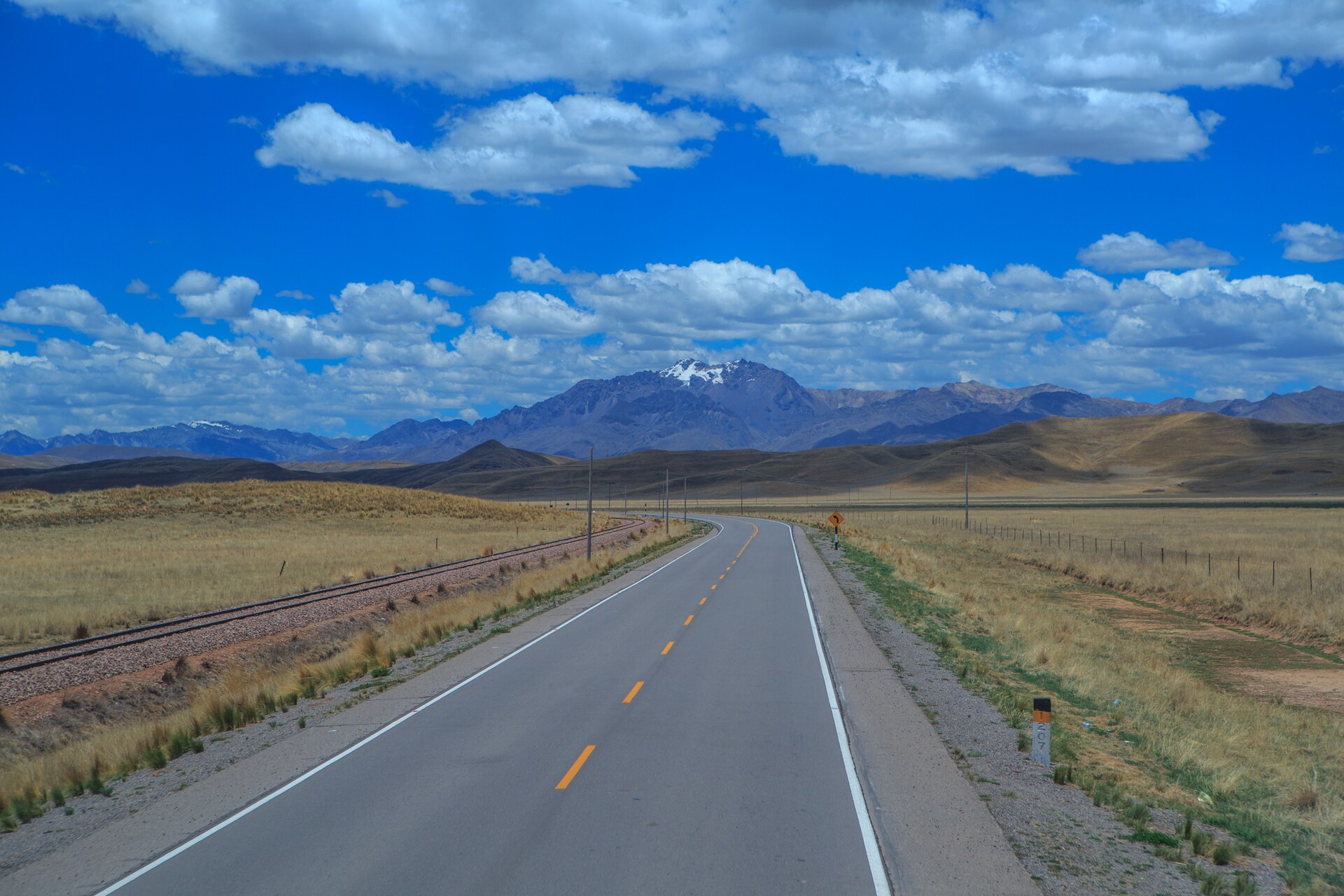 Highland road between Puno and Cusco with a mountain horizon in Peru