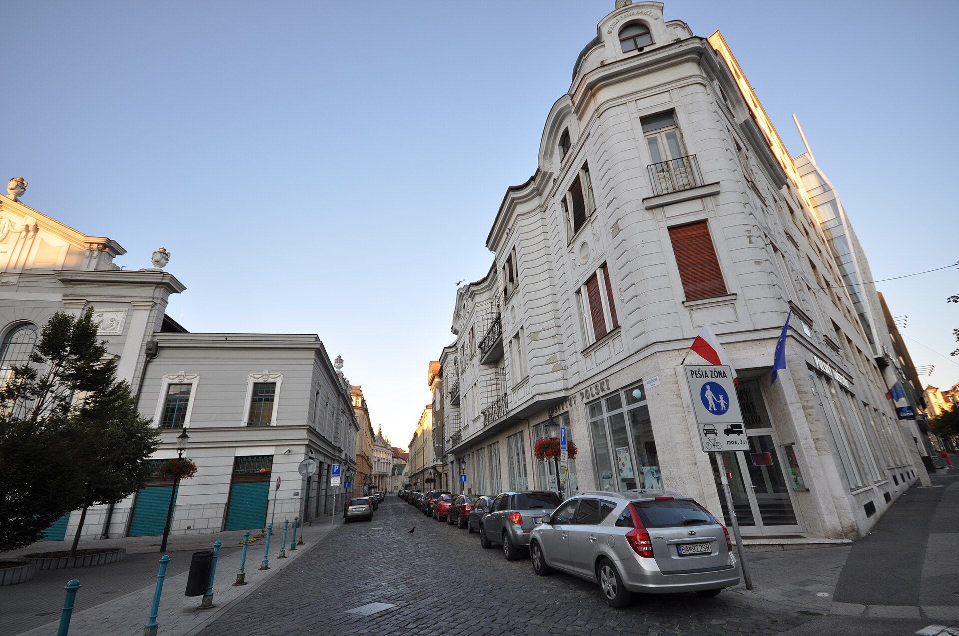 Marked parking and a pedestrian zone sign on a historic street in Bratislava, Slovakia