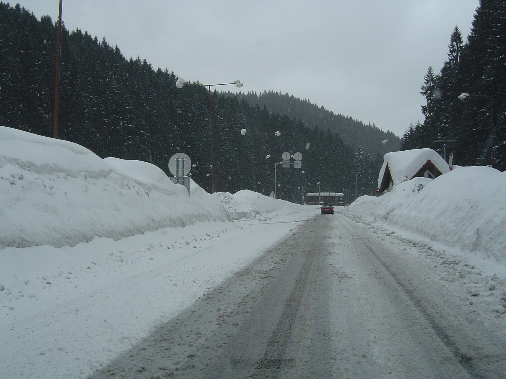 Snow-covered road through the forest at Jasná in the Low Tatras of Slovakia