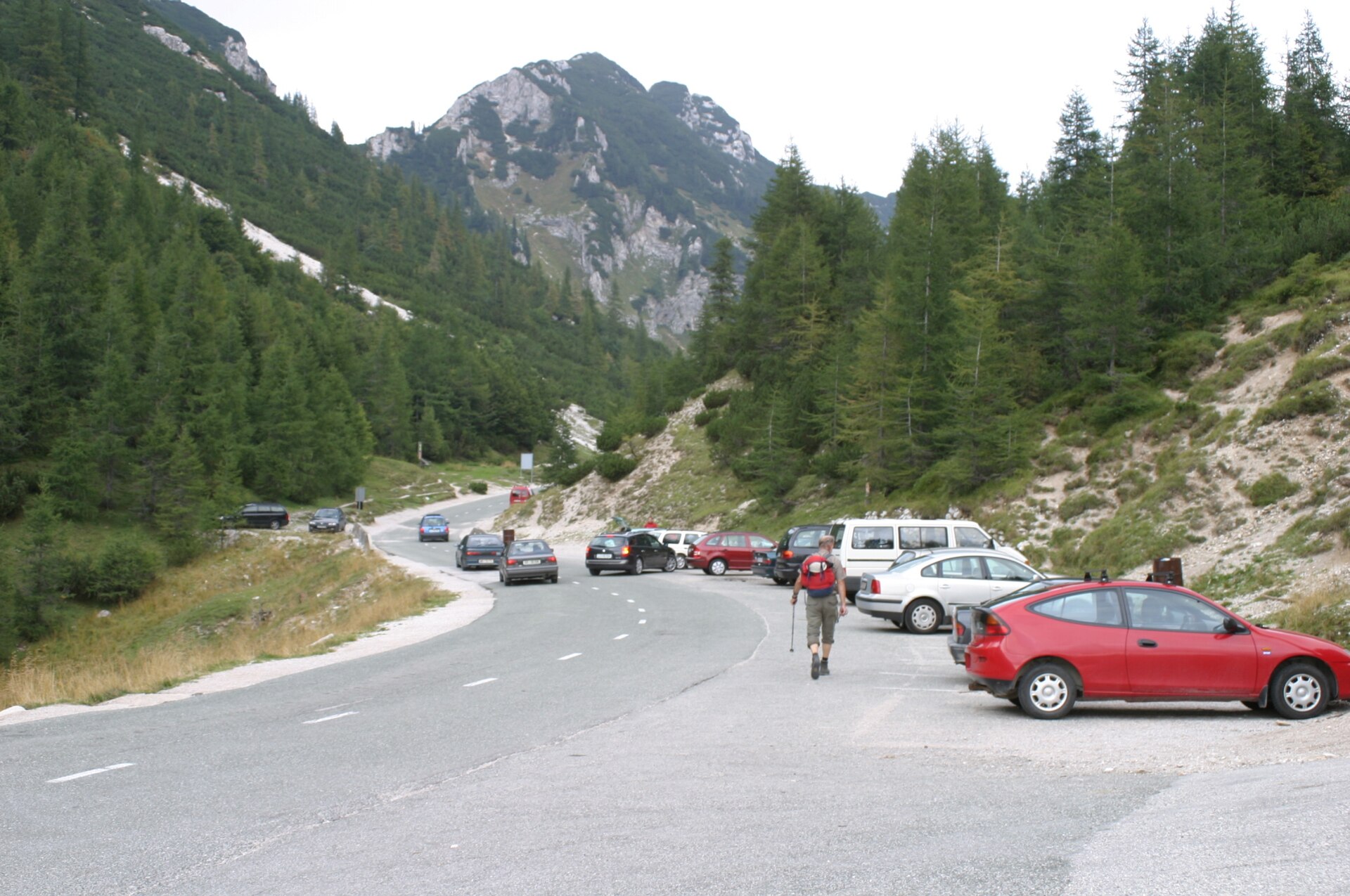 Cars and a narrow mountain road at Vršič Pass in Slovenia