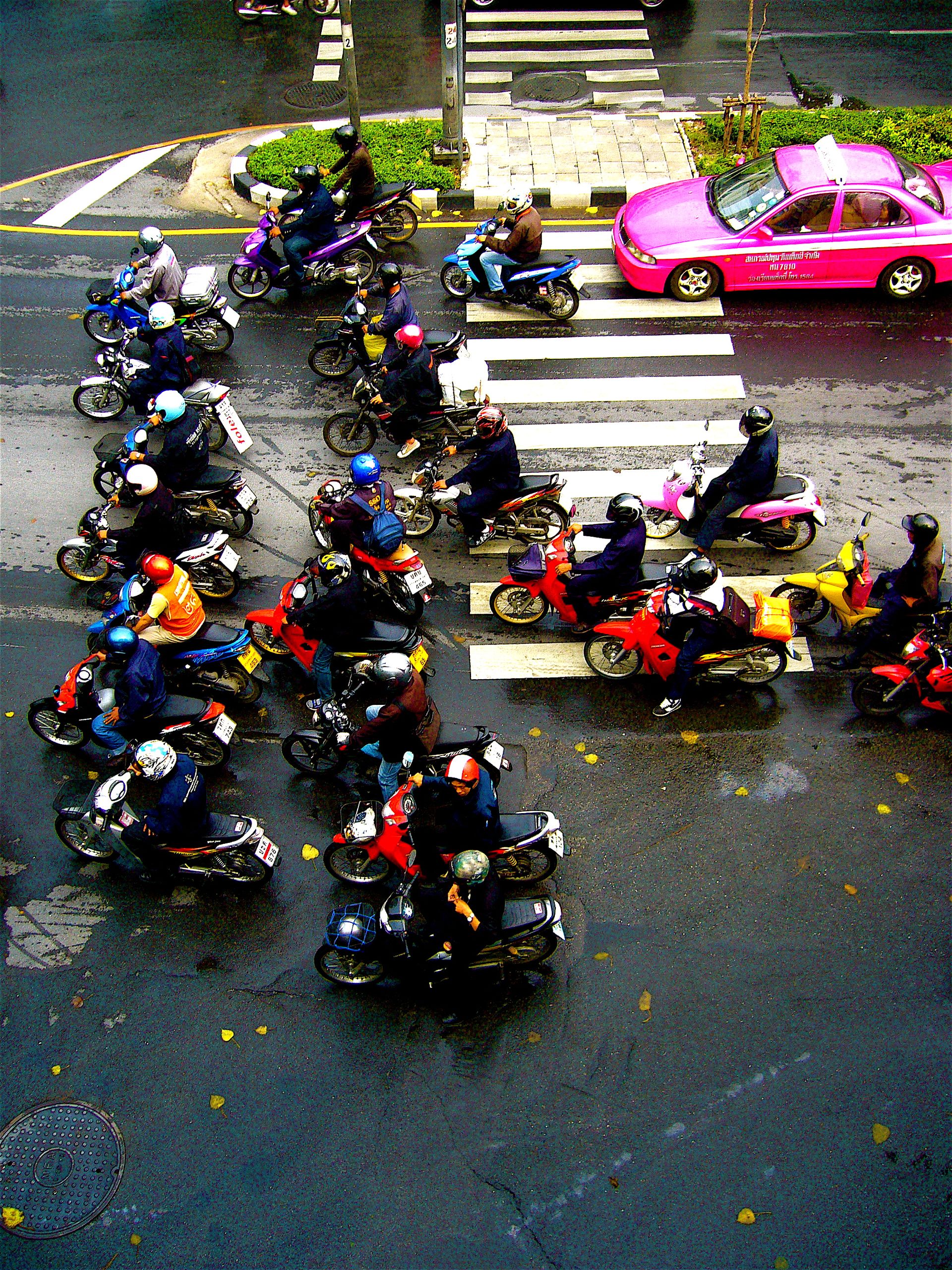 Motorcycles filling lanes in Bangkok traffic